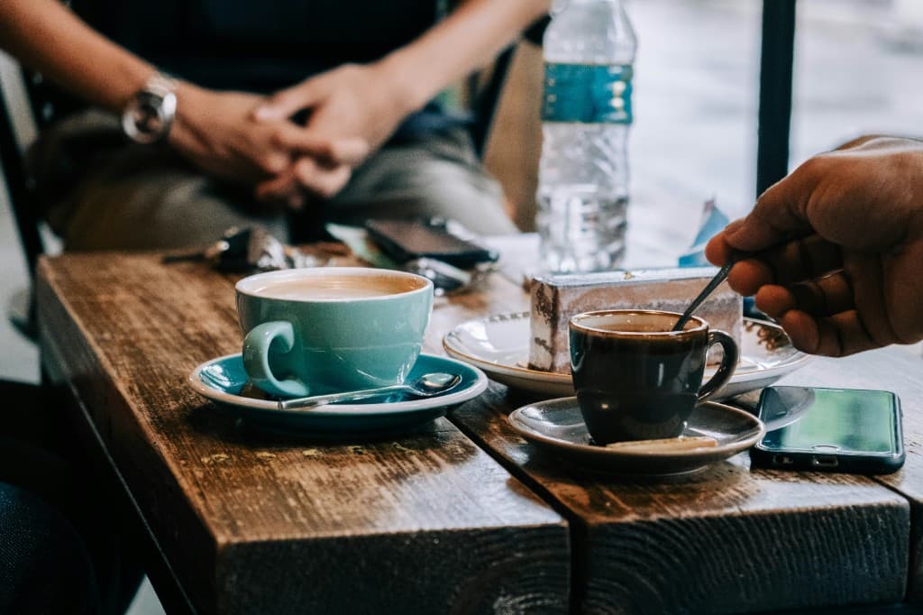 Coffee and conversation at a cafe table